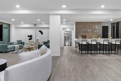 Inspiration for a large modern open concept medium tone wood floor and brown floor living room remodel in Other with white walls