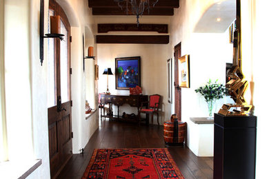 Example of a mid-sized eclectic dark wood floor hallway design in Seattle with beige walls