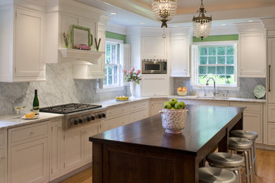 Elegant kitchen photo in Philadelphia with shaker cabinets, white cabinets and white backsplash