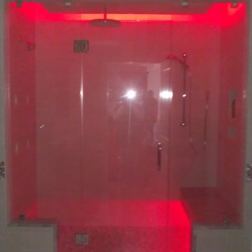 Frameless Glass Shower with Bench Seat and Custom Lighting