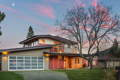 Example of a multicolored two-story mixed siding house exterior design in Other with a shed roof