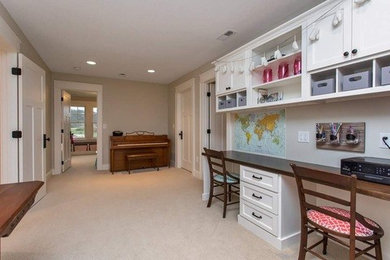 Home office - farmhouse built-in desk carpeted home office idea in Other with beige walls
