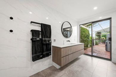 Modern 3/4 bathroom in Perth with a corner shower, white tile, ceramic tile, white walls, ceramic floors, grey floor and an open shower.