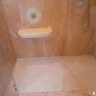 Inspiration for a large timeless 3/4 pink tile and marble tile marble floor and pink floor walk-in shower remodel in Milan with recessed-panel cabinets, light wood cabinets, a two-piece toilet, pink walls, an undermount sink, marble countertops, a hinged shower door and pink countertops