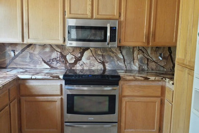 Inspiration for a kitchen remodel in San Francisco with a single-bowl sink, stone slab backsplash, stainless steel appliances and no island