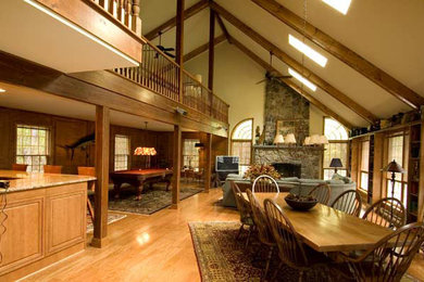 Example of a large mountain style medium tone wood floor great room design in Philadelphia with white walls, a standard fireplace and a stone fireplace