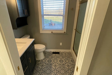 Bathroom - mid-sized country vinyl floor and single-sink bathroom idea in St Louis with shaker cabinets, blue cabinets, quartz countertops, white countertops and a built-in vanity