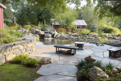 Koi pond with natural stone patio, steps, and retaining wall