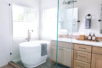Example of a mountain style porcelain tile freestanding bathtub design in Denver with an undermount sink, quartzite countertops and a hinged shower door