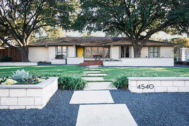 Example of a large transitional rectangular pool design in Dallas with decking