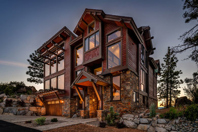 Example of a large trendy three-story wood exterior home design in Other