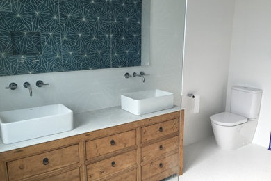 Photo of a large contemporary kids bathroom in Sydney with furniture-like cabinets, an open shower, a one-piece toilet, blue tile, white walls, a pedestal sink and marble benchtops.