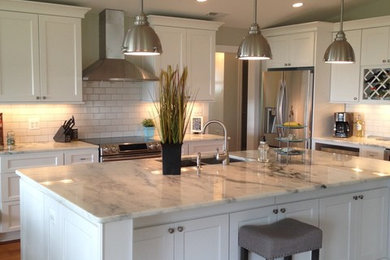 Open concept kitchen - large country l-shaped medium tone wood floor and brown floor open concept kitchen idea in DC Metro with an undermount sink, shaker cabinets, white cabinets, quartz countertops, white backsplash, ceramic backsplash, stainless steel appliances and an island