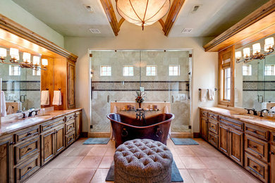 Huge tuscan master beige tile travertine floor and brown floor bathroom photo in Dallas with an undermount sink, dark wood cabinets, beige walls, a hinged shower door, beige countertops and recessed-panel cabinets