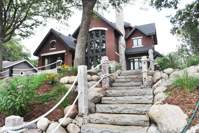 Photo of a mid-sized rustic partial sun hillside stone landscaping in Other for summer.