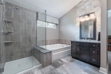 Inspiration for a mid-sized transitional master multicolored tile and porcelain tile porcelain tile and gray floor corner shower remodel in Chicago with shaker cabinets, dark wood cabinets, gray walls, an undermount sink, granite countertops and a hinged shower door