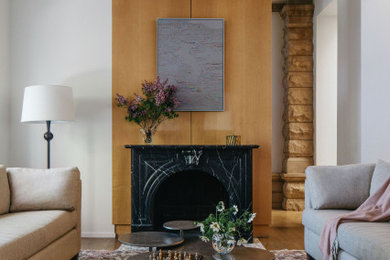 Inspiration for a transitional medium tone wood floor and brown floor living room remodel in Chicago with white walls and a standard fireplace