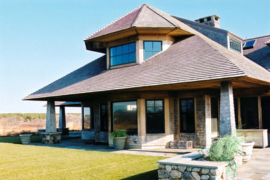 Huge elegant brown two-story wood exterior home photo in Boston with a hip roof