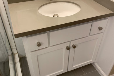 Mid-sized contemporary master bathroom in San Francisco with shaker cabinets, white cabinets, a corner shower, a one-piece toilet, white tile, porcelain tile, white walls, porcelain floors, an undermount sink, engineered quartz benchtops, grey floor, a hinged shower door, grey benchtops, a niche, a double vanity and a built-in vanity.