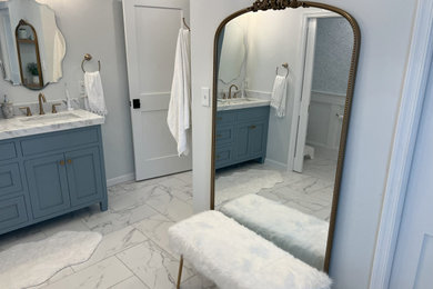 Large double-sink freestanding bathtub photo in Philadelphia with shaker cabinets, blue cabinets, an undermount sink, quartzite countertops and a hinged shower door