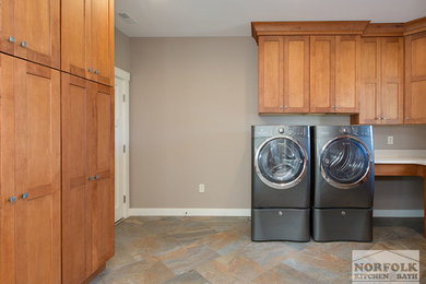 Inspiration for a large transitional u-shaped utility room remodel in Boston with an undermount sink, shaker cabinets, medium tone wood cabinets, quartz countertops and a side-by-side washer/dryer