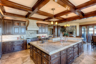 This is an example of a large kitchen in New York with travertine floors, with island and beige floor.