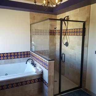 Großes Mediterranes Badezimmer En Suite mit profilierten Schrankfronten, dunklen Holzschränken, Einbaubadewanne, bodengleicher Dusche, farbigen Fliesen, Keramikfliesen, Keramikboden, Unterbauwaschbecken, Mineralwerkstoff-Waschtisch, Falttür-Duschabtrennung und weißer Waschtischplatte in Denver