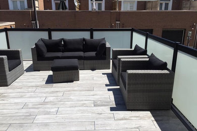 Example of a mid-sized minimalist rooftop deck design in Calgary with no cover