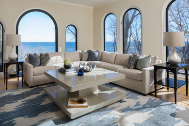 Inspiration for a large transitional formal open concept living room in Milwaukee with beige walls and light hardwood floors.