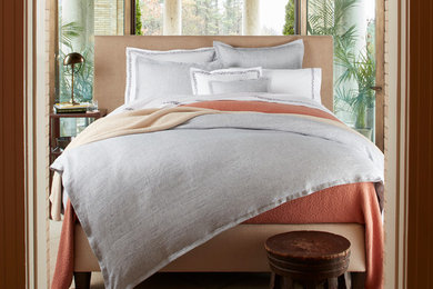 Inspiration for a mid-sized tropical master ceramic tile and brown floor bedroom remodel in Tampa with no fireplace and beige walls