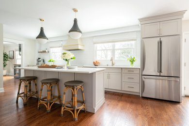 Inspiration for a large transitional galley dark wood floor eat-in kitchen remodel in Philadelphia with a drop-in sink, shaker cabinets, beige cabinets, quartz countertops, white backsplash, cement tile backsplash, stainless steel appliances, an island and white countertops