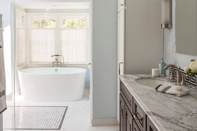 Inspiration for a large contemporary master black tile and cement tile marble floor and white floor bathroom remodel in Boston with raised-panel cabinets, dark wood cabinets, a two-piece toilet, blue walls, an undermount sink and granite countertops