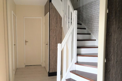 This is an example of a mid-sized beach style foyer in Other with beige walls, vinyl floors and beige floor.