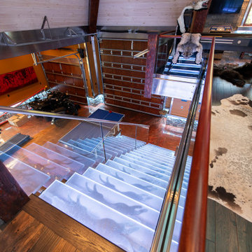 Glass private bar and glass stair treads inside a man cave in Michigan