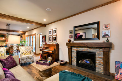 Photo of an expansive country open concept living room in Sacramento with white walls, dark hardwood floors, a standard fireplace, a tile fireplace surround, no tv and brown floor.
