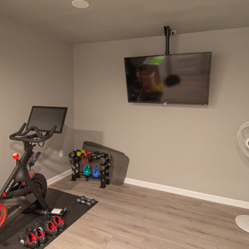 Basement Utilizing Open Space to Shoot Pool and Watch Favorite Sports Team
