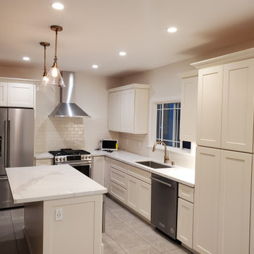 open concept kitchen with island and subway back splash