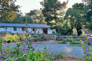 Inspiration for a huge farmhouse drought-tolerant and full sun front yard mulch and wood fence flower bed in San Diego.