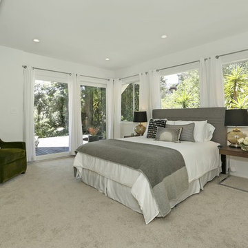 Grey headboard, green accent chair, glass table lamps