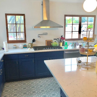 Design ideas for a mid-sized modern u-shaped kitchen pantry in Los Angeles with an undermount sink, shaker cabinets, blue cabinets, quartzite benchtops, stainless steel appliances, porcelain floors, with island and blue floor.