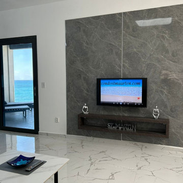 Living Room Marble Accent TV Wall & Ocean View Sliding Glass Door