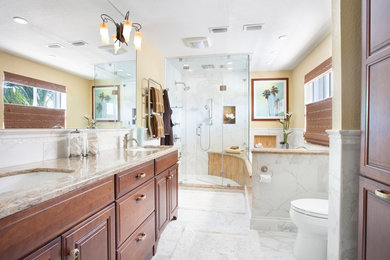 Inspiration for a large traditional master bathroom in Miami with an undermount sink, recessed-panel cabinets, medium wood cabinets, engineered quartz benchtops, an alcove tub, a corner shower, a two-piece toilet, yellow tile, beige walls, porcelain floors, white floor and a hinged shower door.
