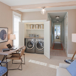 Design ideas for a nautical laundry cupboard in Grand Rapids with beige walls, carpet, a side by side washer and dryer and beige floors.