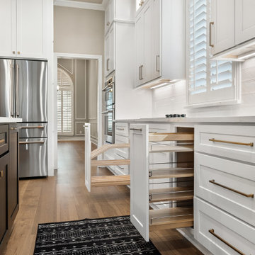 View of White Custom Kitchen Cabinets with Open Spice Rack Pull-Out and Mixer Li