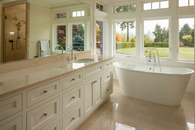 Inspiration for a large transitional master stone tile marble floor freestanding bathtub remodel in Other with recessed-panel cabinets, white cabinets, marble countertops and white walls