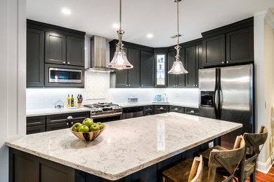 Mid-sized transitional l-shaped kitchen in Boston with an undermount sink, shaker cabinets, grey cabinets, quartzite benchtops, white splashback, subway tile splashback, stainless steel appliances, medium hardwood floors, with island and brown floor.