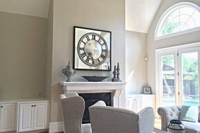 Example of a mid-sized transitional formal and enclosed light wood floor living room design in Atlanta with beige walls, a standard fireplace, a wood fireplace surround and no tv