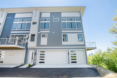 Large contemporary gray three-story mixed siding apartment exterior idea in Grand Rapids