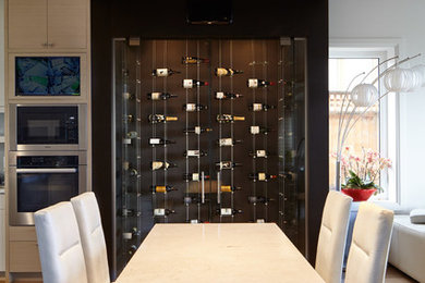 Example of a mid-sized trendy medium tone wood floor wine cellar design in Vancouver