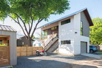Example of a small transitional white two-story concrete fiberboard gable roof design in Austin